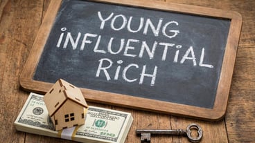 Young influential rich concept with cash house model and key for wealth real estate and financial