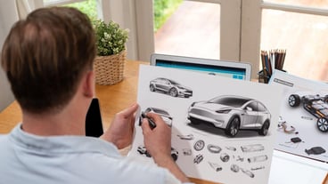 Car designer carefully analyzing car prototype synchronos