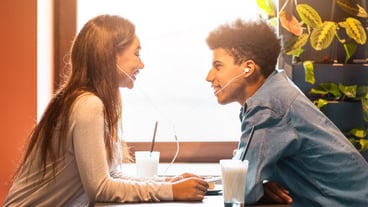 A young african american couple shares an intimate moment listening to music through shared earbuds