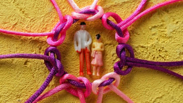 Braided multicolored cords painted tied together The concept of creative cooperation and teamwork