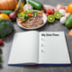 Journal with a diet plan on a kitchen table surrounded by healthy products dieting concept