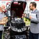 Tractor dealer presenting agricultural machines and modern engine to the farmer at dealership