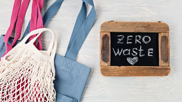 Flat lay of Zero waste kit. Set of eco friendly reusable mesh cotton bag. Sustainable, ethical, plastic free lifestyle concept. Top view