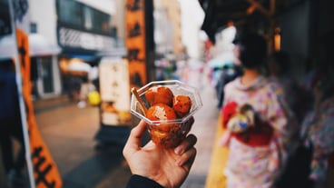 Midsection of man holding ice cream in city