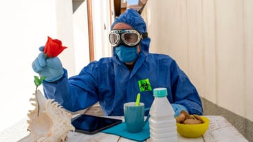 Man wearing protective workwear sitting at table