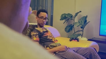 Portrait of young man sitting on his couch at home