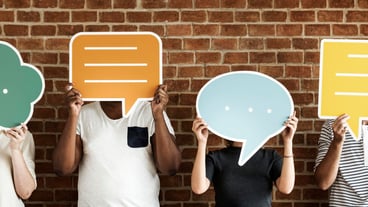 People holding speech bubble icons