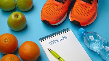 Orange sneakers fruit and bottle of water on a blue background