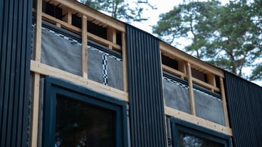 House Under Construction with Vertical Cladding and Ventilation System