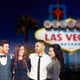 friends in party clothes hugging at las vegas