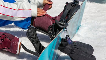 Female snowboarder wears snowboard equipment