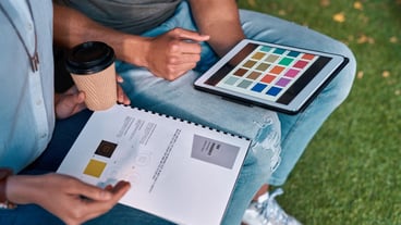 People tablet and grass with paperwork discussion and working for creative collaboration Colleagues product design and astro turf for startup business and employees on break for fashion company