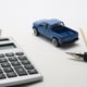 High angle view of diary with pen and toy car on white background