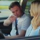 Young woman and driving school instructor with clipboard talking in car Woman listening to instructor in car learning to drive