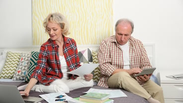 Senior couple calculating taxes at home