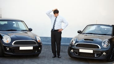 Business man thinking and choice of car at dealership shop and store Confused customer and decision for motor vehicle sales doubt to buy convertible and shopping for auto transportation outdoor