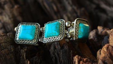 gemstoneTurquoise is a turquoise bracelet placed on the flor