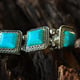 gemstoneTurquoise is a turquoise bracelet placed on the flor