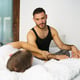 Young man lying in bed at home