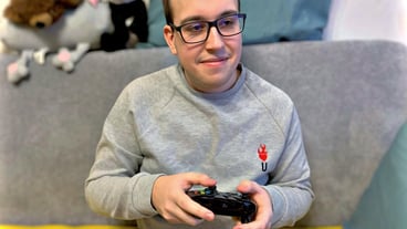 Portrait of young man sitting on sofa at home
