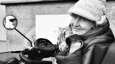 Portrait of senior woman wearing warm clothing and knit hat in city