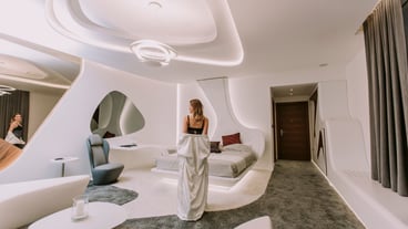 Pretty young woman standing in the modern apartment