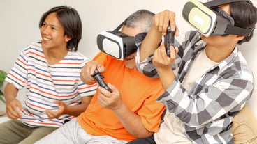 Happy Asian Father And Son Wearing VR Glasses And Playing Video Games Together