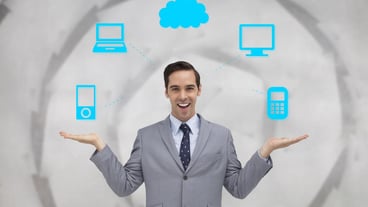 Smiling businessman presenting graphics with his hands against sheet spiral on grey wall