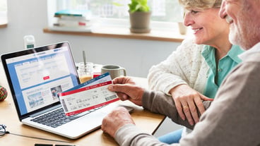 Senior Adult Holding Plane Ticket Concept