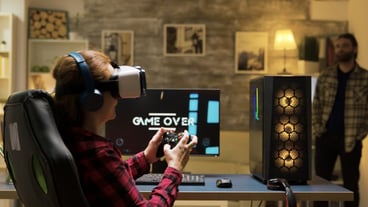 Woman relaxing playing video games using vr headset. Game over for female gamer. Man in the background.