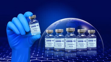 Doctors Hand in blue gloves hold the vial with vaccine or drug on blue background