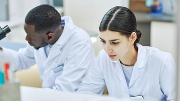 High angle view of two workers in laboratory doing medical research
