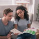 House design. Joyful young couple looking together at the colors while choosing house design