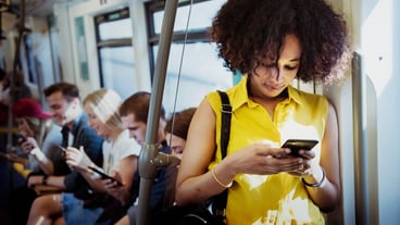 Young woman using a smartphone in the subway