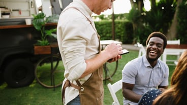 Waiter checking order of clients