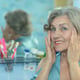 Senior woman in a bathroom with cream