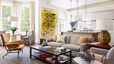 a living room with a large painting on the wall