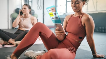 Fitness phone or black woman on social media at gym relaxing on a break after workout Girl overlay or healthy sports athlete resting scrolling on app after training with alert or notification