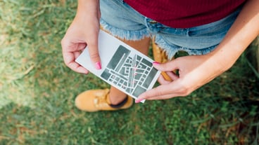 Top view of woman holding a directions card