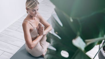 A woman in her prime, just over forty, doing yoga exercises. A woman with healthy, well-groomed skin and hair, a fit figure and a healthy twinkle in her eye.