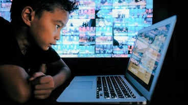 Boy uses laptop