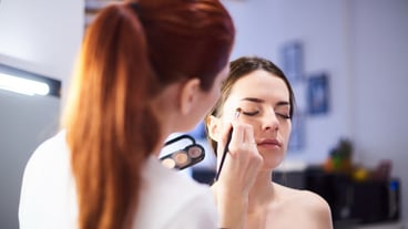 Make-up artist doing make-up beautiful girl in the salon, beauty concept and style.