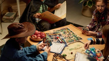 Kids in costumes playing board game