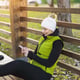Woman Texting on Her Phone While Resting on a Park Bench