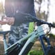 Hand cycling and outdoor with wrist pain and injury from fitness and mountain bike training Athlete muscle strain and sport accident with a person in nature for workout on bicycle with problem
