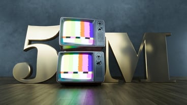 golden number 5m five million social media followers with old retro television on dark background