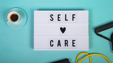 Self care word on lightbox on blue background Take care of yourself