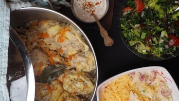 A bowl of food with a spoon next to it