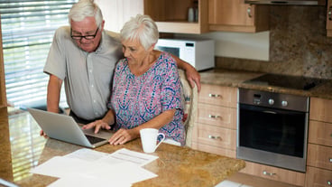 Senior woman using laptop in the kitchen at home