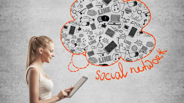 Woman using tablet with media icons
